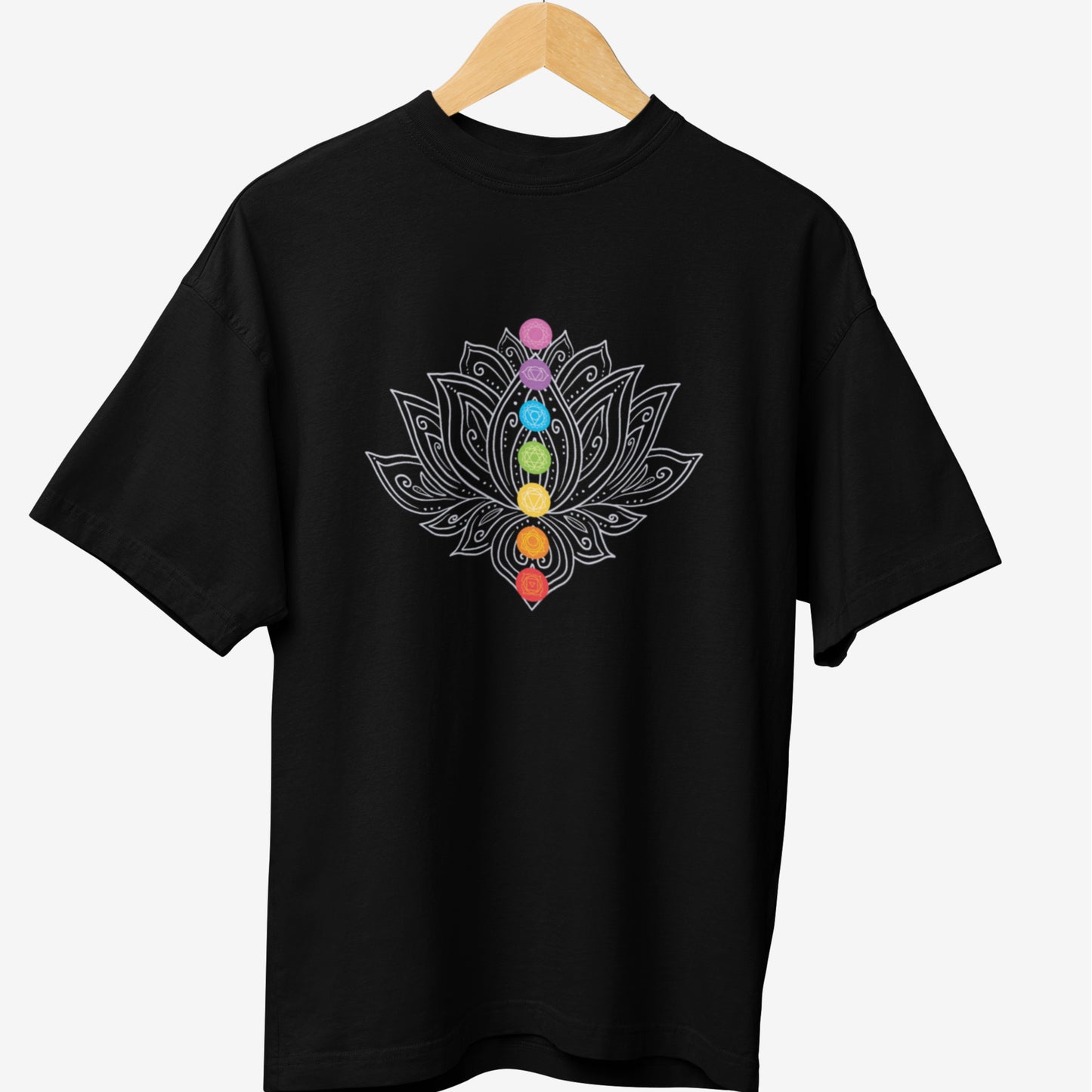 Black yoga t-shirt featuring an intricate white lotus design with seven colorful chakra symbols aligned in the center, representing balance, spirituality, and meditation.