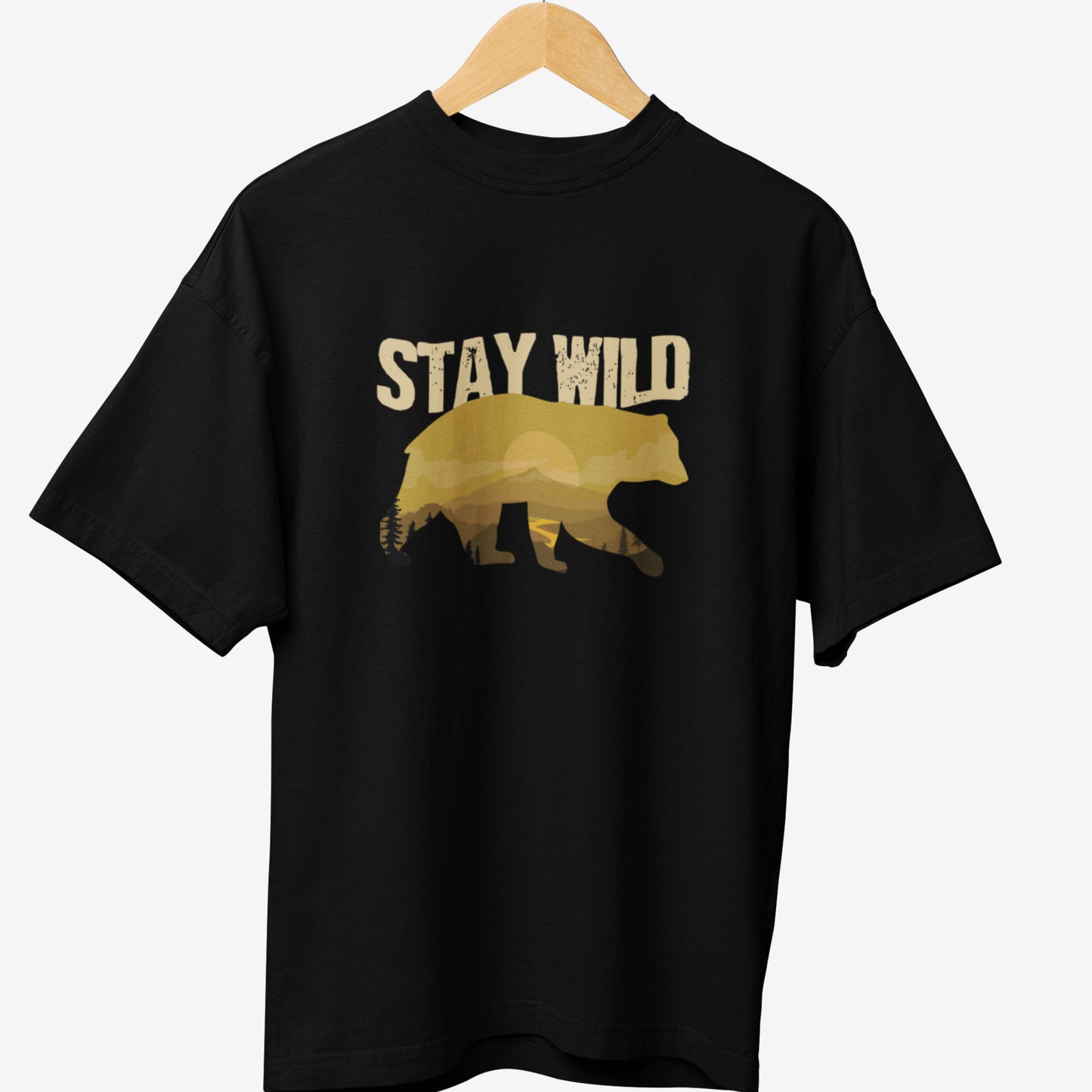 Black travel t-shirt featuring a golden bear silhouette with a mountain landscape inside and the bold text 'Stay Wild,' symbolizing adventure and the spirit of exploration.