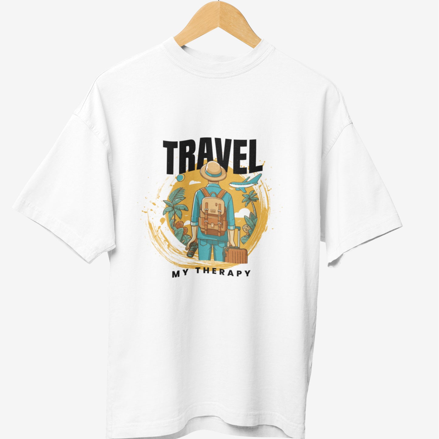 White travel t-shirt featuring a graphic of a traveler with a backpack and suitcase, surrounded by tropical elements, an airplane, and the bold text 'TRAVEL MY THERAPY' in a modern design.