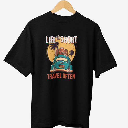 Black travel t-shirt featuring a vintage-style design with the phrase 'LIFE IS SHORT, TRAVEL OFTEN,' an old-school car carrying luggage, palm trees, and a sunset background, perfect for adventure lovers