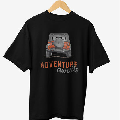Black travel t-shirt featuring a graphic design of an off-road Jeep in orange and gray, with the text 'ADVENTURE awaits' in bold, distressed typography.